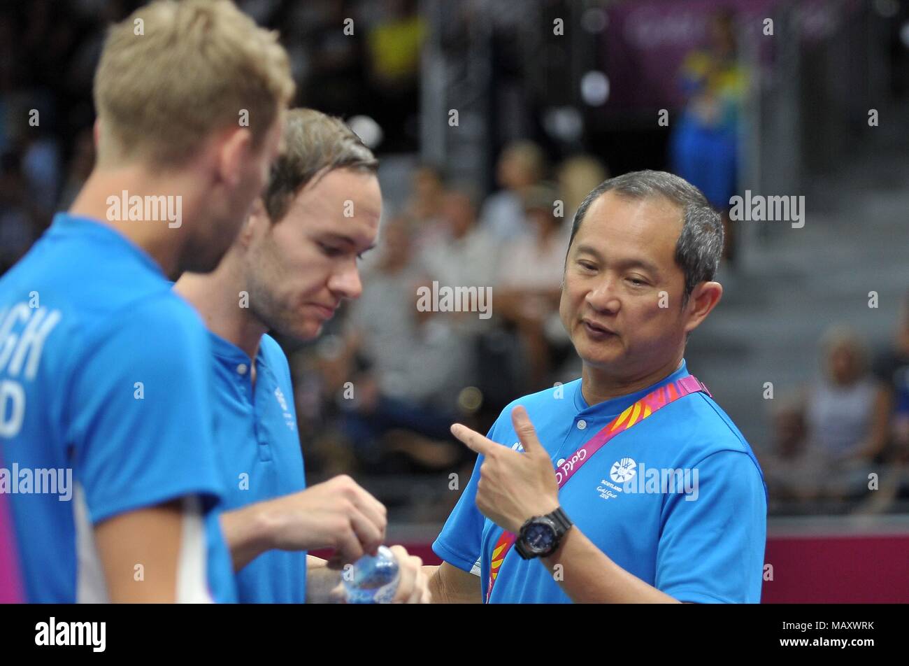 Queensland, Australia. 5th April 2018. Coach Tat Meng Wong (SCO) speaks to Martin CAMPBELL (SOC) and Patrick MACHUGH (SOC) in the mens doubles. Badminton. Mixed team event. XXI Commonwealth games. Carrara Sports hall 2. Gold Coast 2018. Queensland. Australia. 05/04/2018. Credit: Sport In Pictures/Alamy Live News Stock Photo