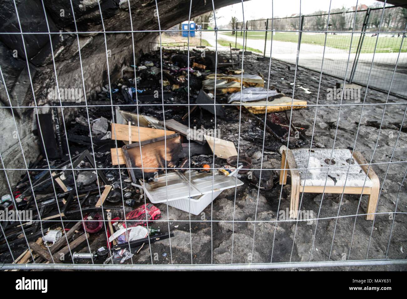 April 5, 2018 - A homeless camp under the ReichenbachbrÃ¼cke (Reichenbach Bridge) in Munich was the target of a suspected arson attack. The photos display the aftermath and the blackening of the surfaces of the bridge, as well as intense heat melting mattresses down to their springs. Damage to the bridge is estimated at 25,000 Euros. Four men, ages 24-53 were living there and unharmed. The suspects may have been two men who were standing near the fire and throwing objects into it. Credit: Sachelle Babbar/ZUMA Wire/Alamy Live News Stock Photo