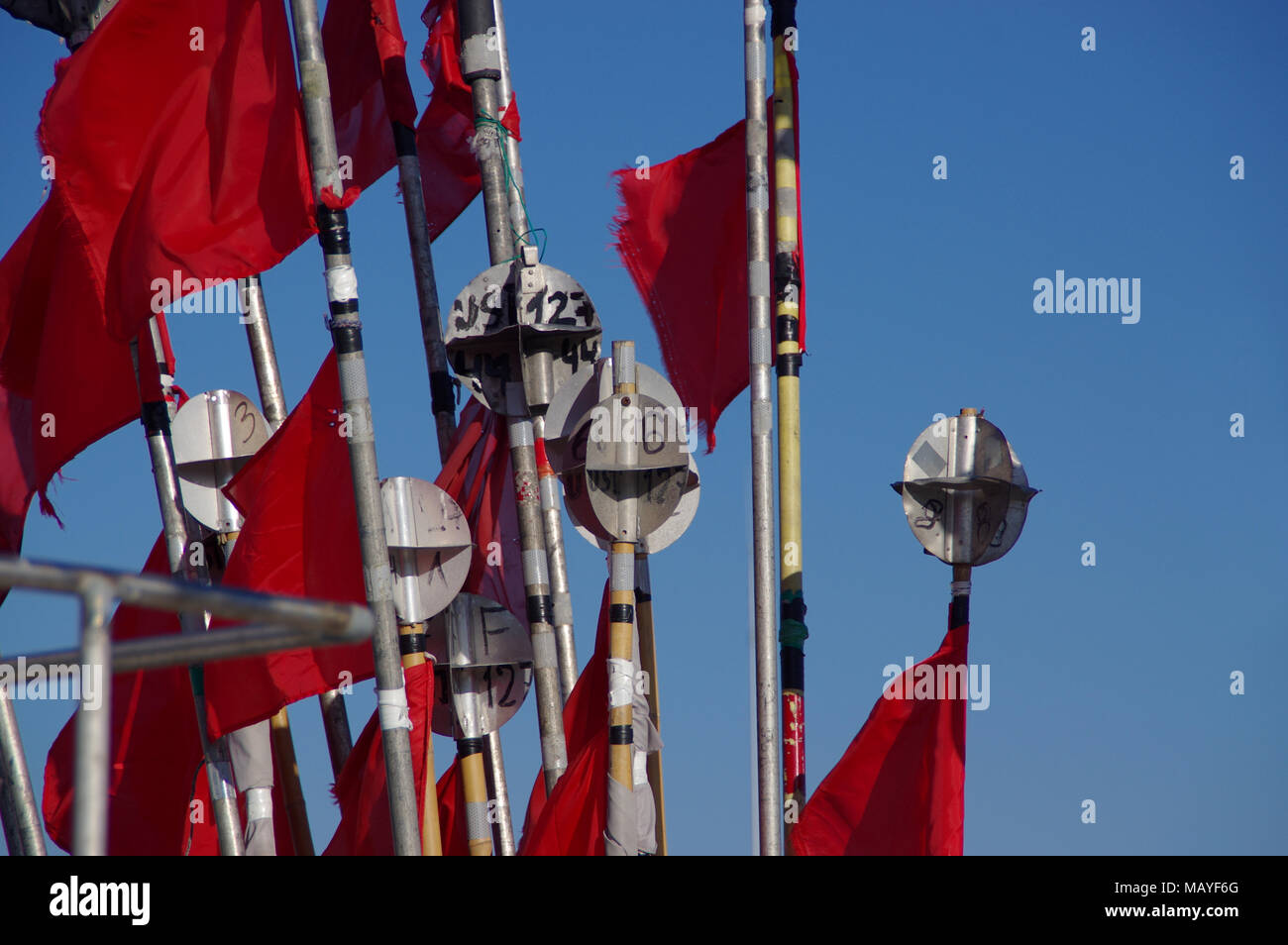 A jagged red flags in the wind on fishing boat Stock Photo