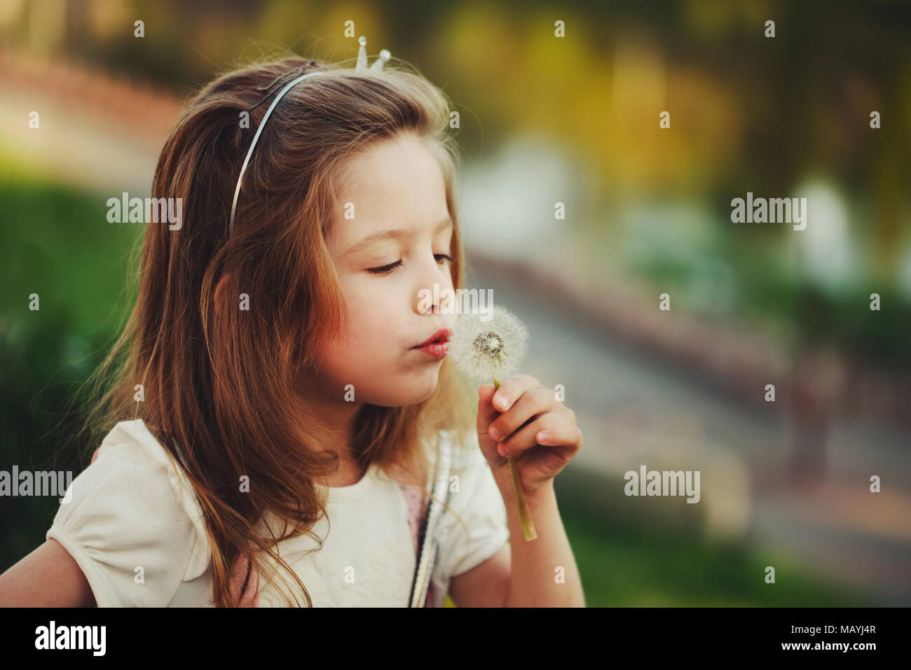 little girl with dandelion in park Stock Photo - Alamy