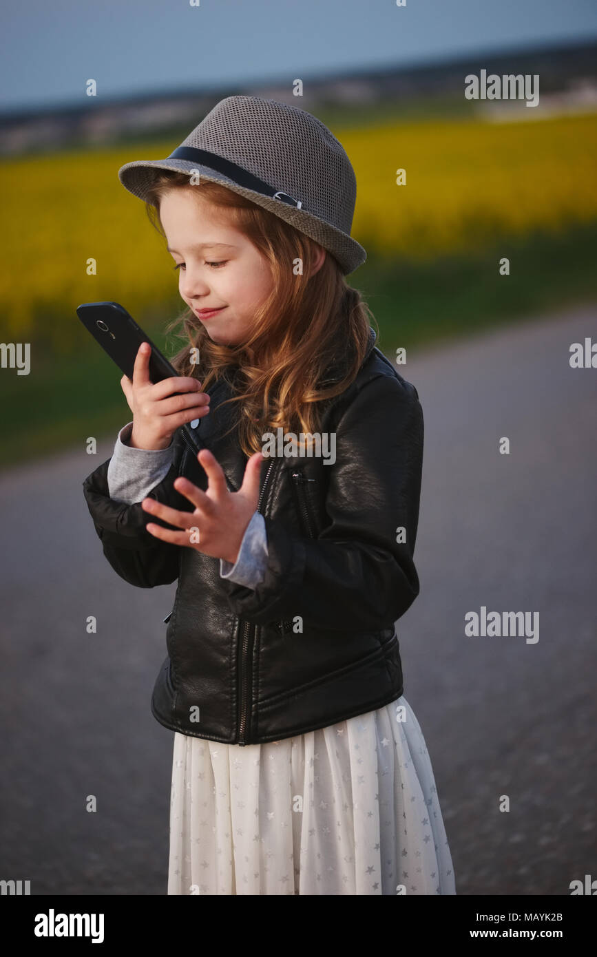 little funny girl with smartphone Stock Photo