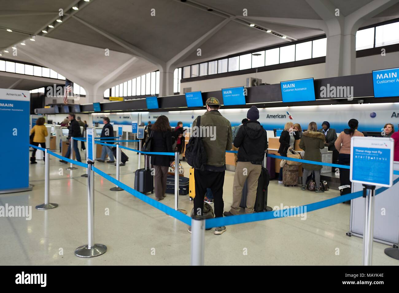 Customers Stand In Line And Prepare To Check In At American