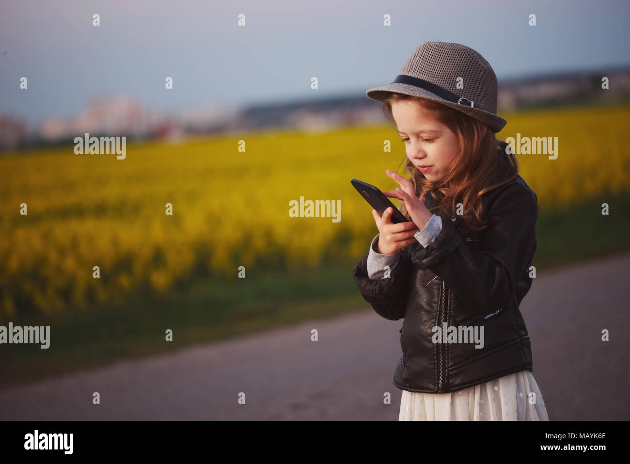 little funny girl with smartphone Stock Photo