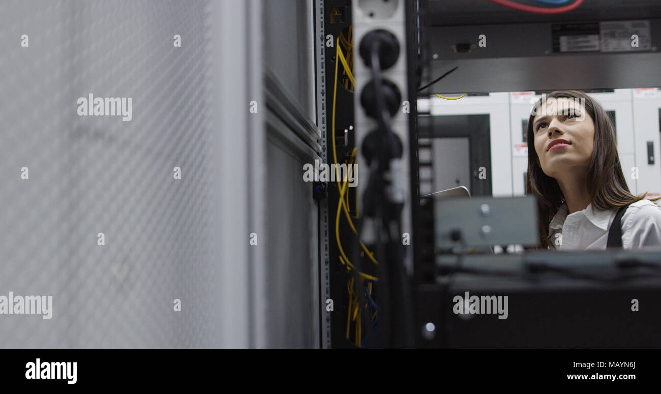 Technicians using laptop while analyzing server in server room Stock Photo