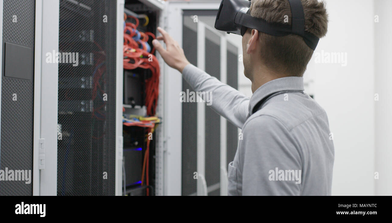 Technicians using laptop while analyzing server in server room Stock Photo