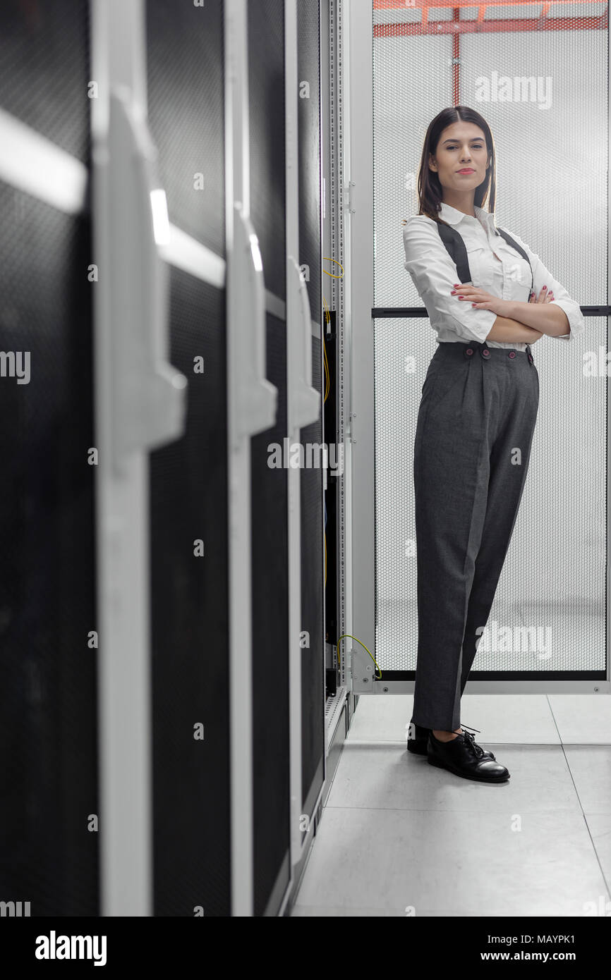 Technicians using laptop while analyzing server in server room Stock Photo