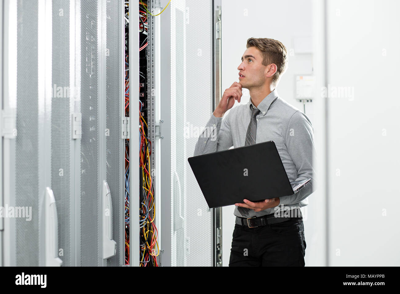 Technicians using laptop while analyzing server in server room Stock ...