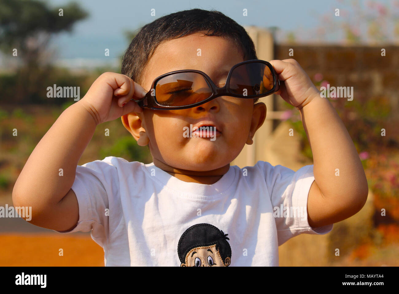 Little boy playing with brown goggle at Palande, Kokan Stock Photo