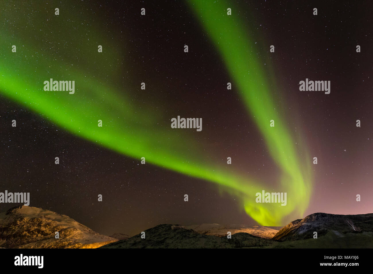 Northern Lights over snow covered mountains, near Tromso, Norway Stock Photo