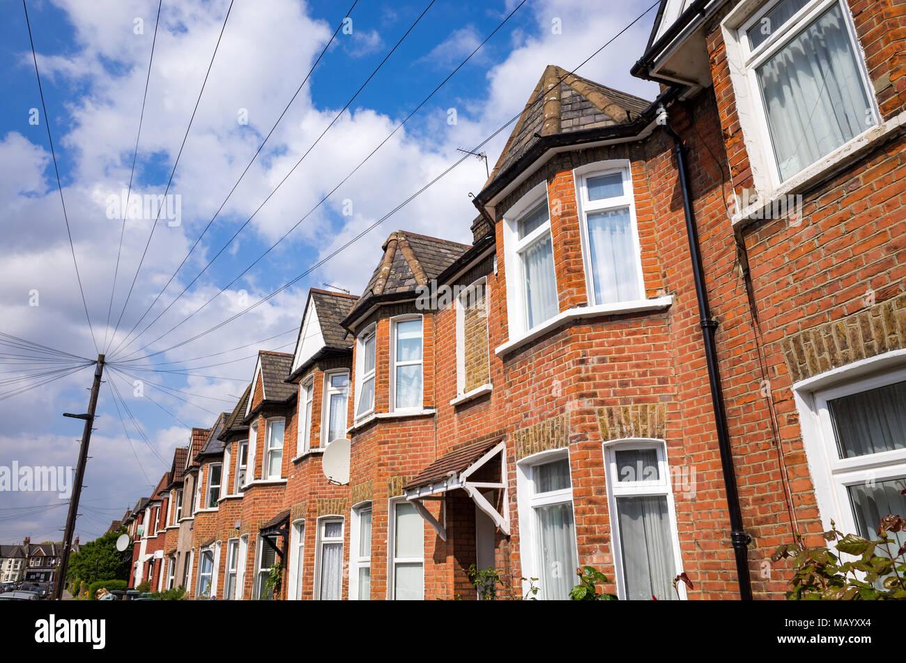 Telephone cables running from post to terraced houses, Haringey, North London, UK Stock Photo