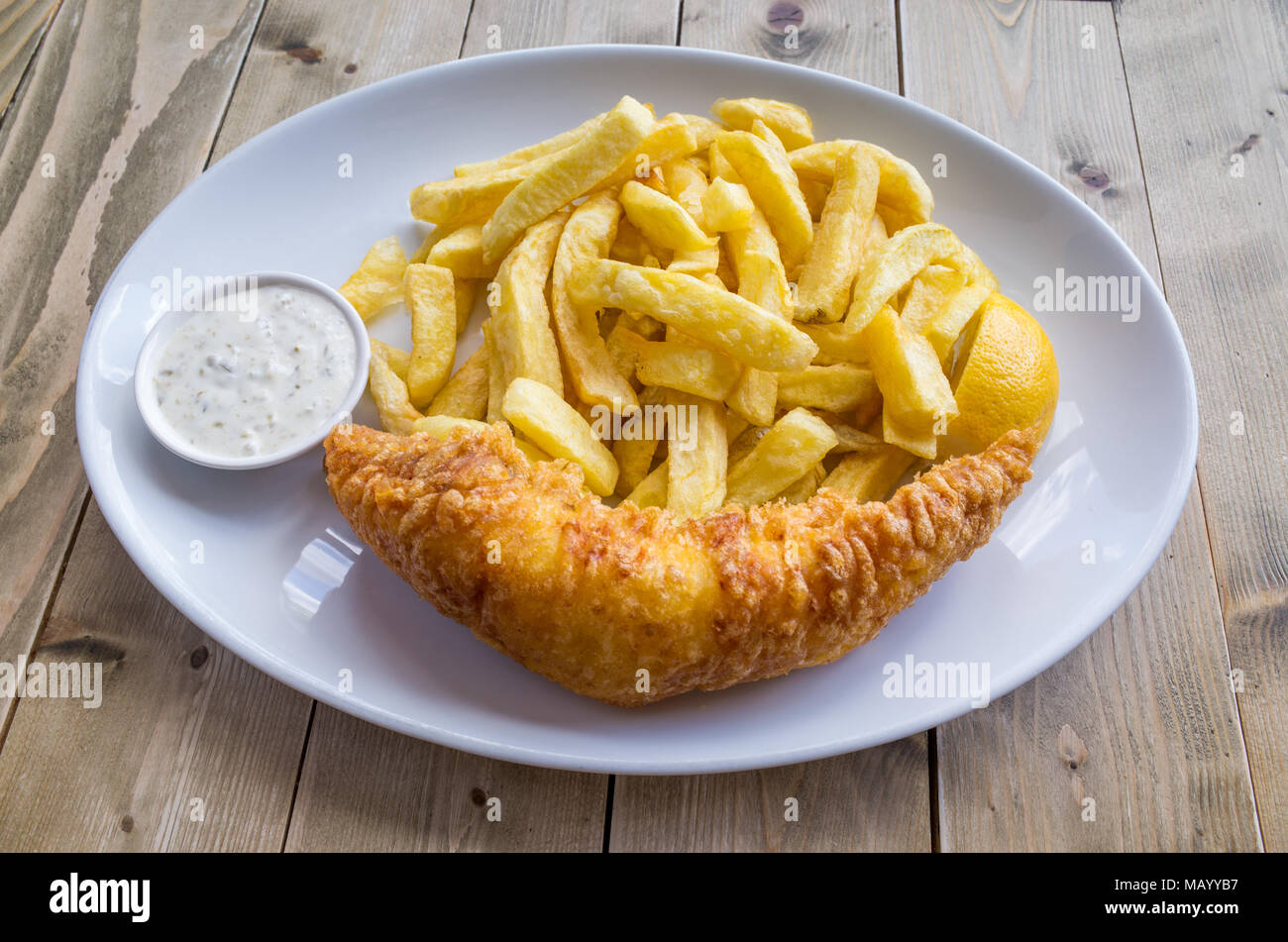 Plate of battered cod and chips, UK Stock Photo