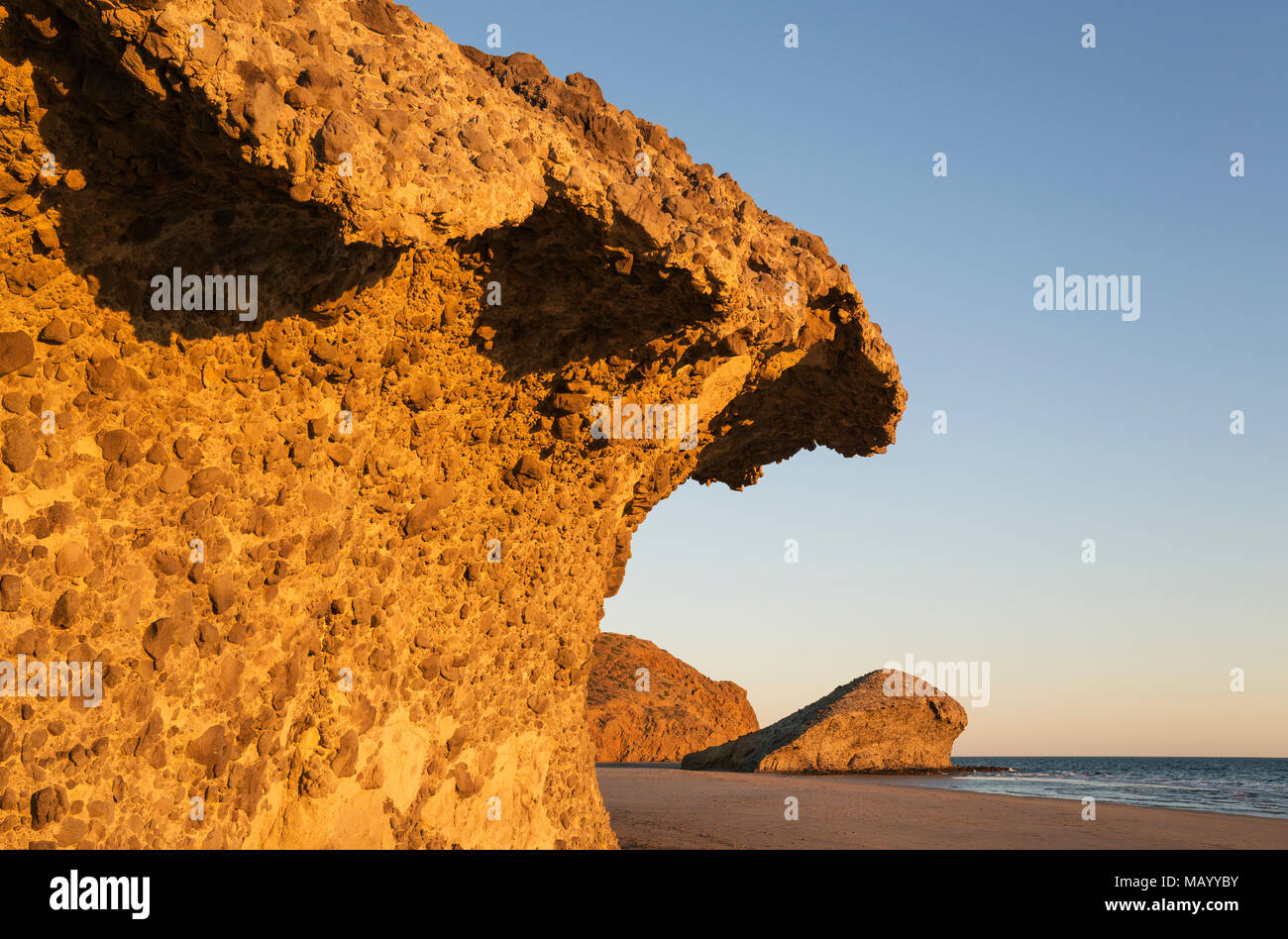 Fossilized lava tongues and walls at the beach Playa del Monsul, Nature Reserve Cabo de Gata-Nijar, Almeria province, Andalusia Stock Photo