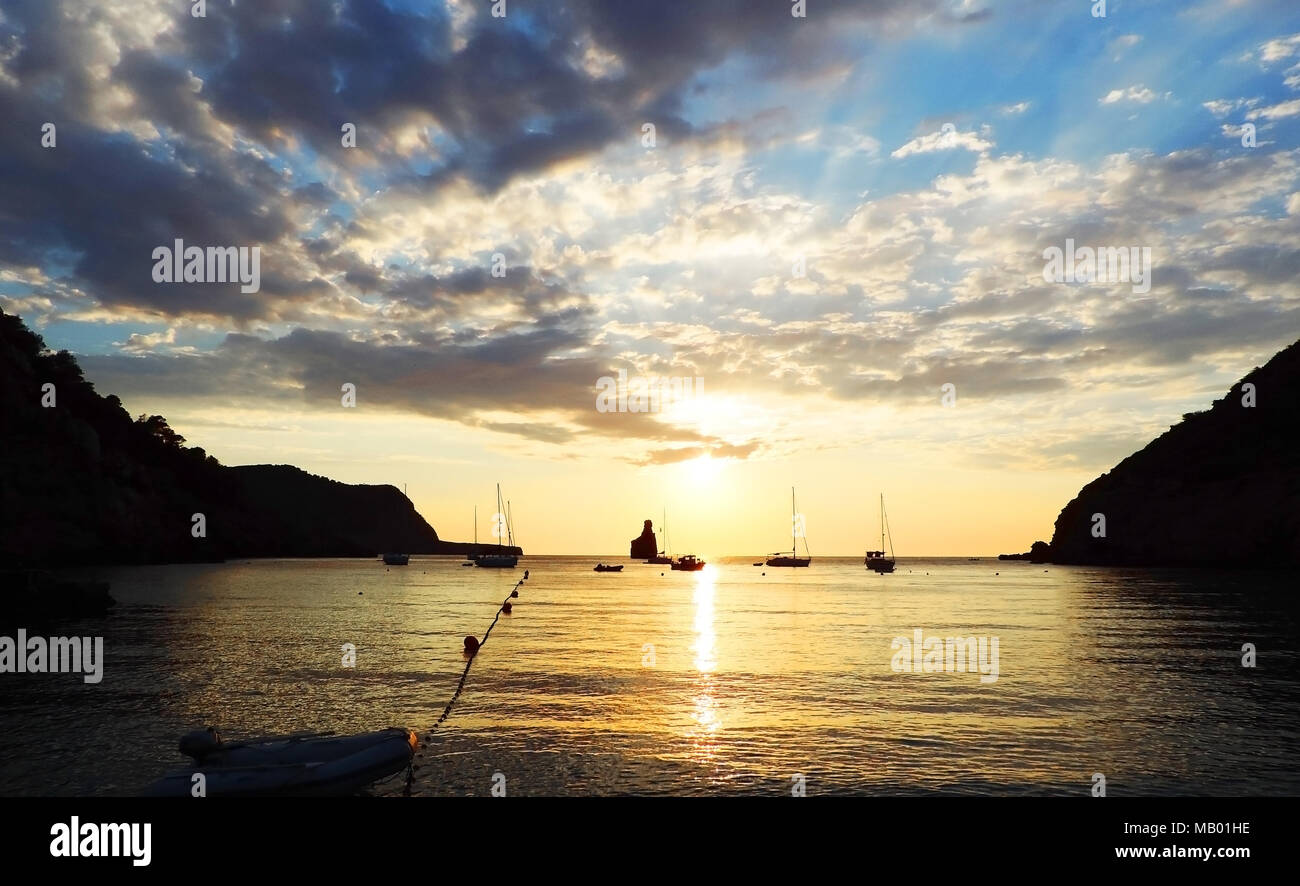 Sunset scene at Benirras beach, Ibiza Island. Rock formation and ...