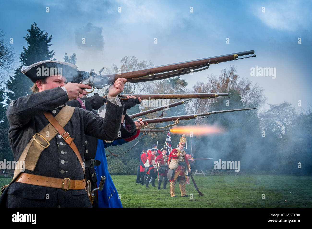 Soldiers fire a volley from their Brown Bess flintlock rifles in a reenactment of the Jacobite rising of 1745. Stock Photo