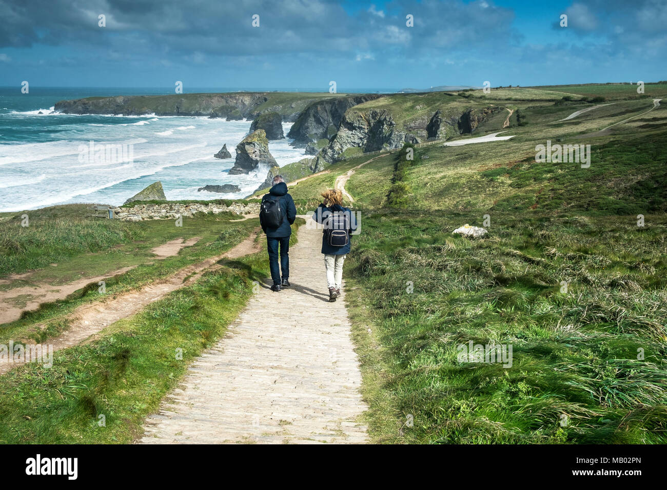 Walkers on the South West Coast Path at Bedruthan Steps on the North Cornwall coast. Stock Photo