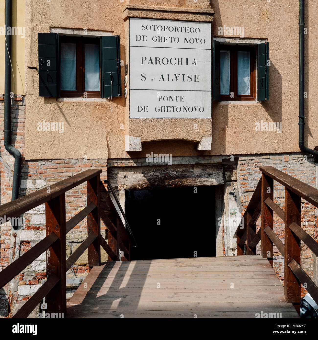 Wooden bridge entrance to an ancient traditional Jewish ghetto of Venice located in the Cannaregio district Stock Photo