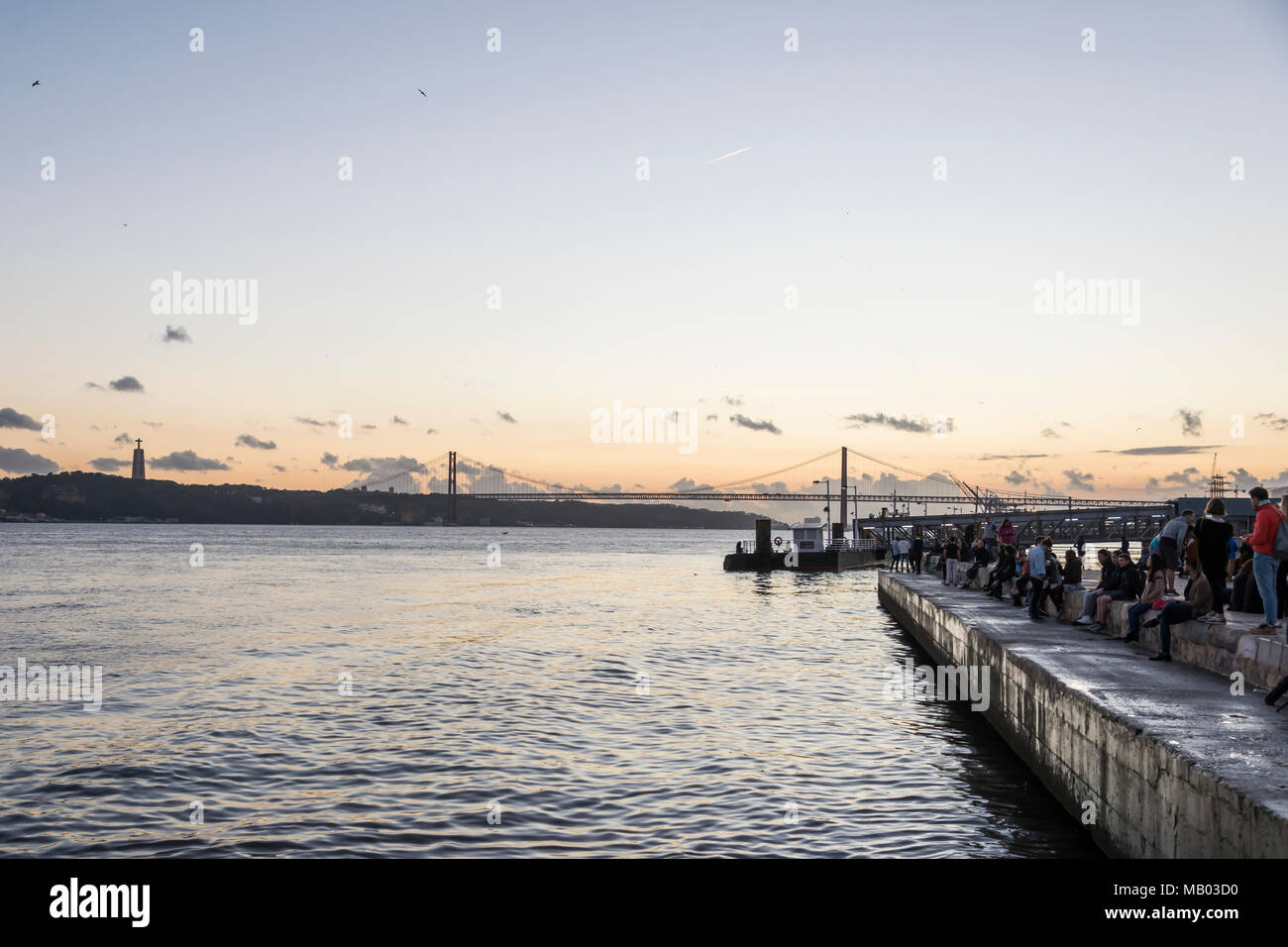 Evening atmosphere by the harbour in Lisbon Stock Photo - Alamy