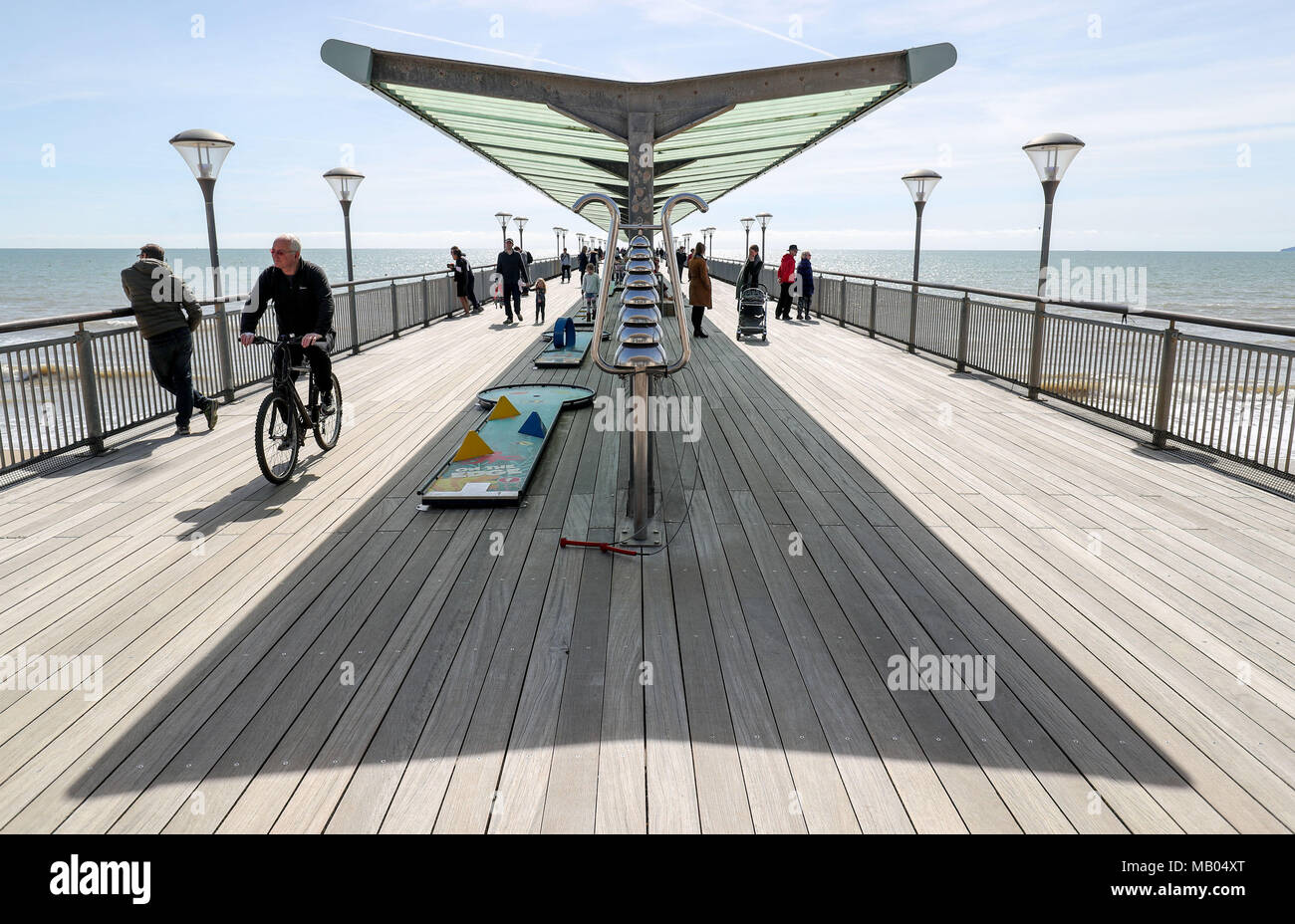 People enjoy the sunny weather on Boscombe pier in Bournemouth, Dorset. Stock Photo