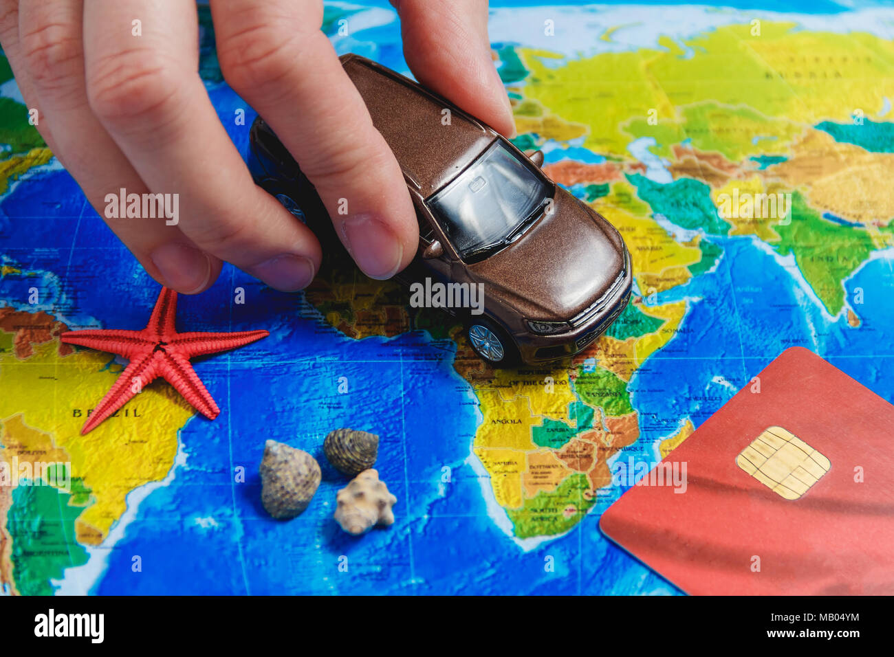 Road Trip Female Hand Hold Car on Map. Route of Automobile Travel