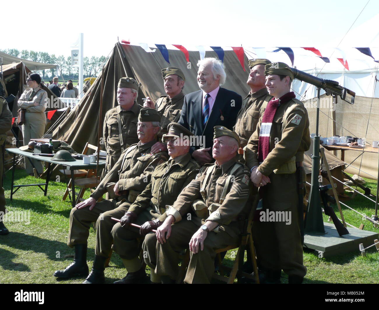 Ian Lavender best known for his role as Private Pike in the BBC comedy series Dad's Army has  fun posing  with actors at the 2009 Goodwood Revival. Stock Photo