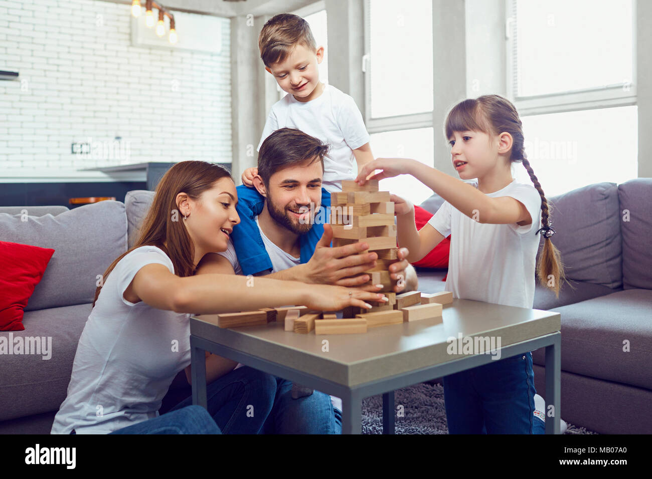 Happy family playing board games at home. Stock Photo