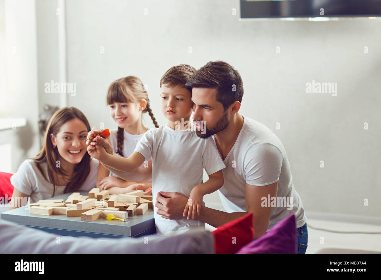 Happy family playing board games at home. Stock Photo