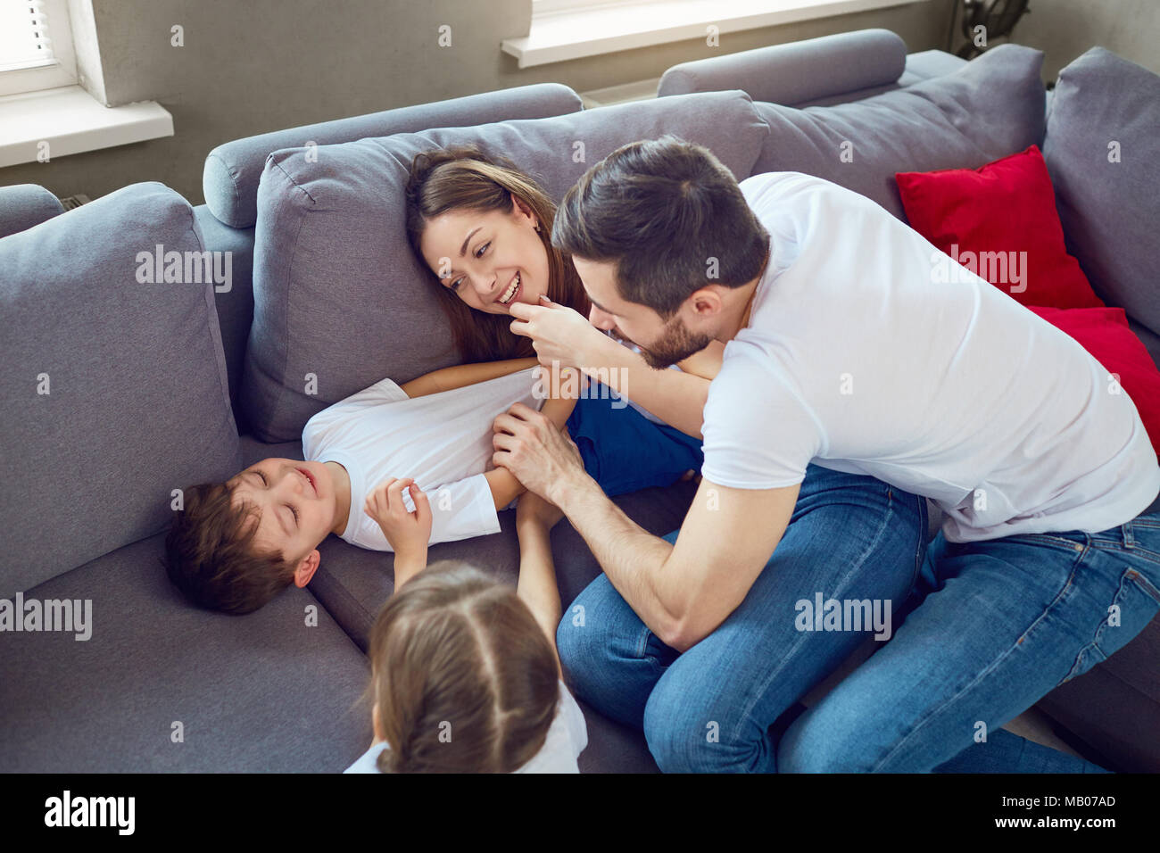 Cheerful family playing together in a room. Stock Photo