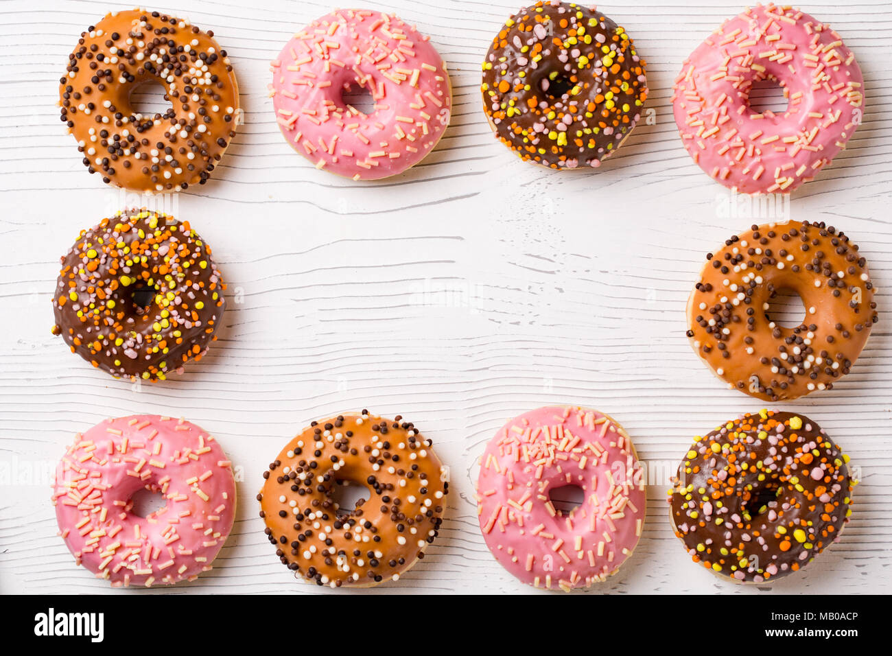 lunch with donuts frame on white wooden table background top view mock ...