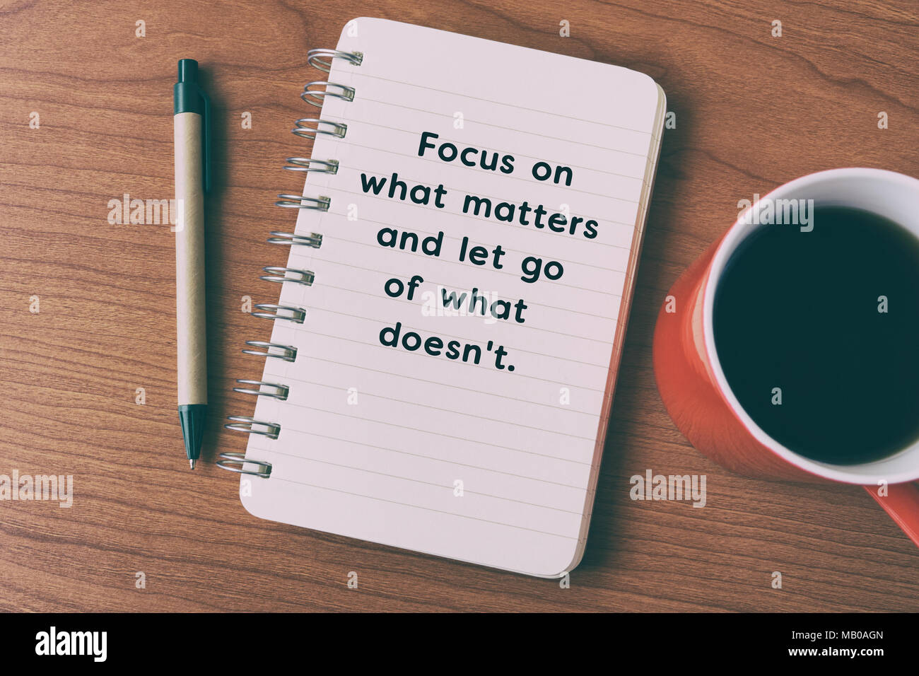 Inspirational quote on notepad - focus on what matters and let go of what doesn't. Stock Photo