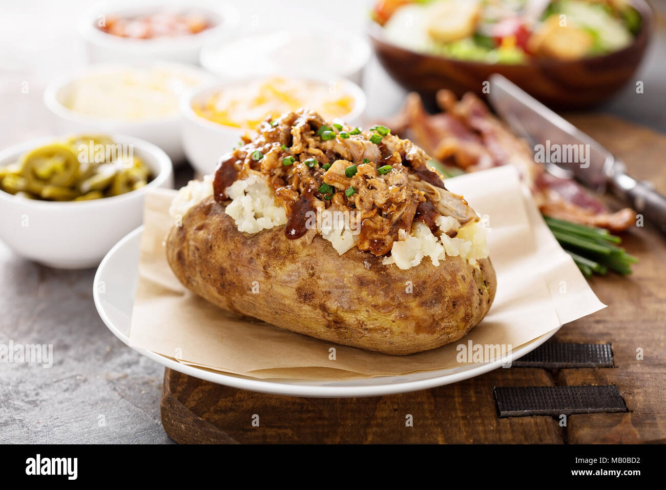 Baked potato with pulled pork and bbq sauce Stock Photo Alamy