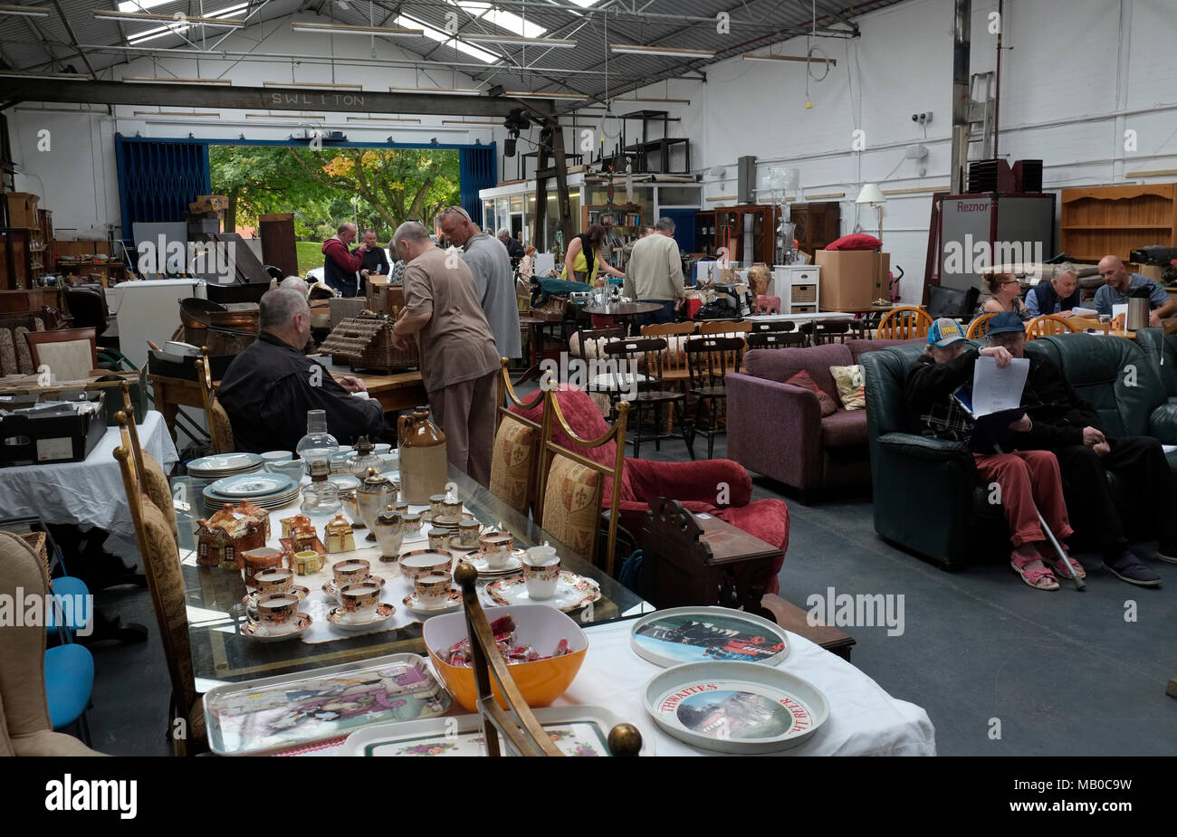People viewing items to be sold in a general auction sale in North West England UK Stock Photo