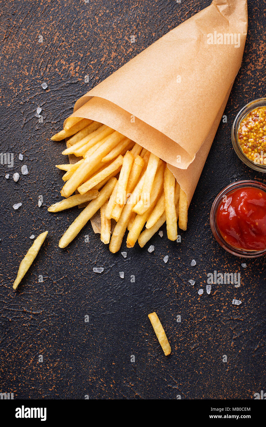 French fries in a paper bag with sauces. Top view Stock Photo - Alamy
