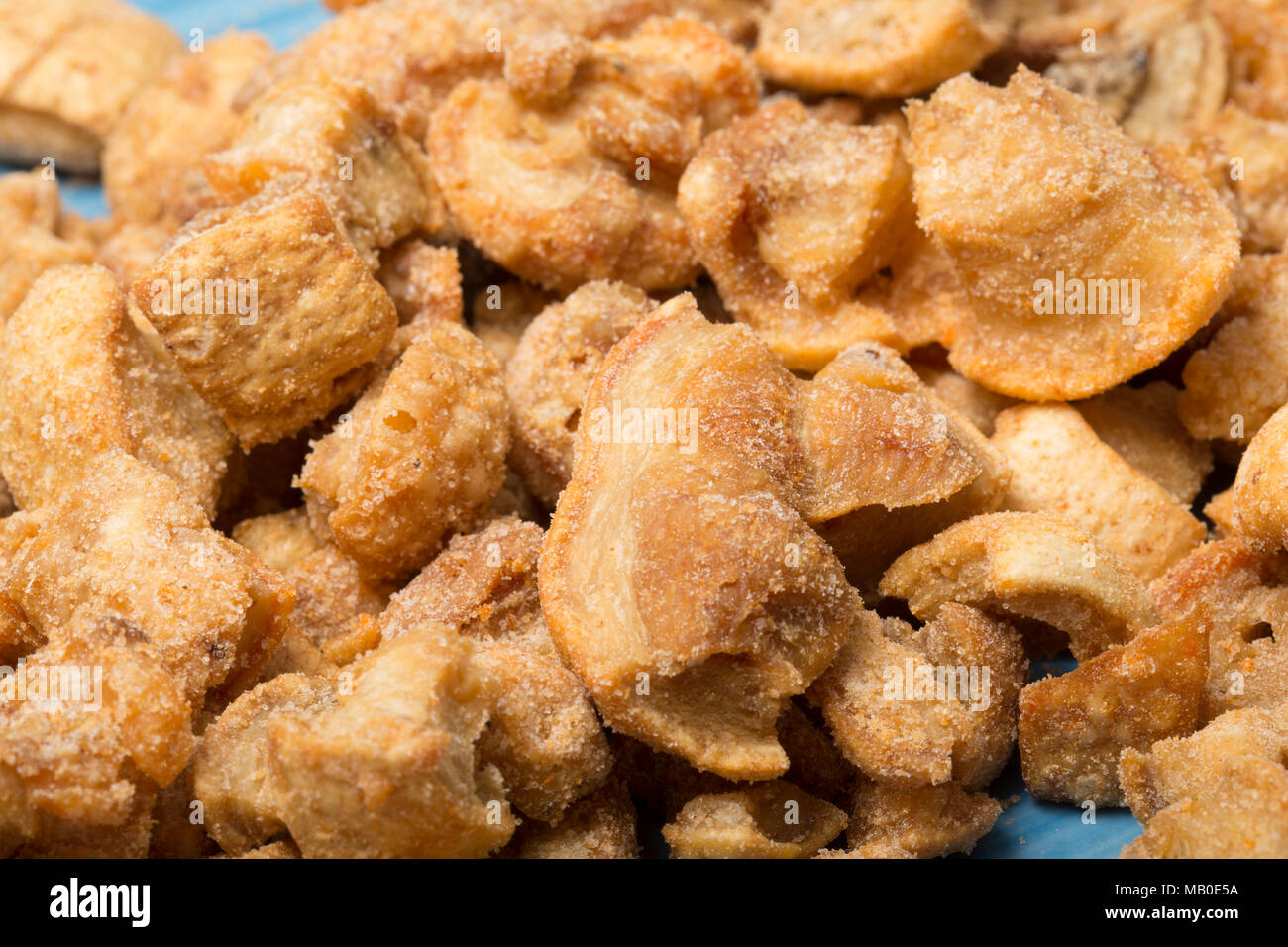 Pork scratchings from a packet bought in a supermarket. UK Stock Photo