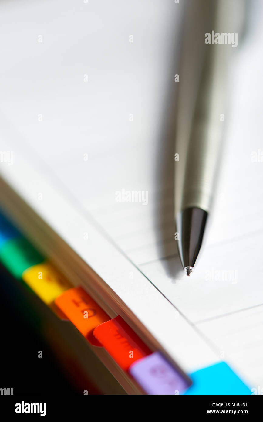 Selective focus alphabetical index address book with mechanical pencil. Stock Photo