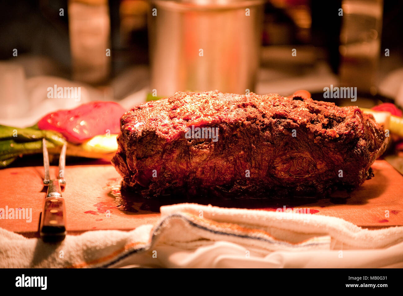 A big piece of steak on a cutting board ready to be served at a party Stock Photo