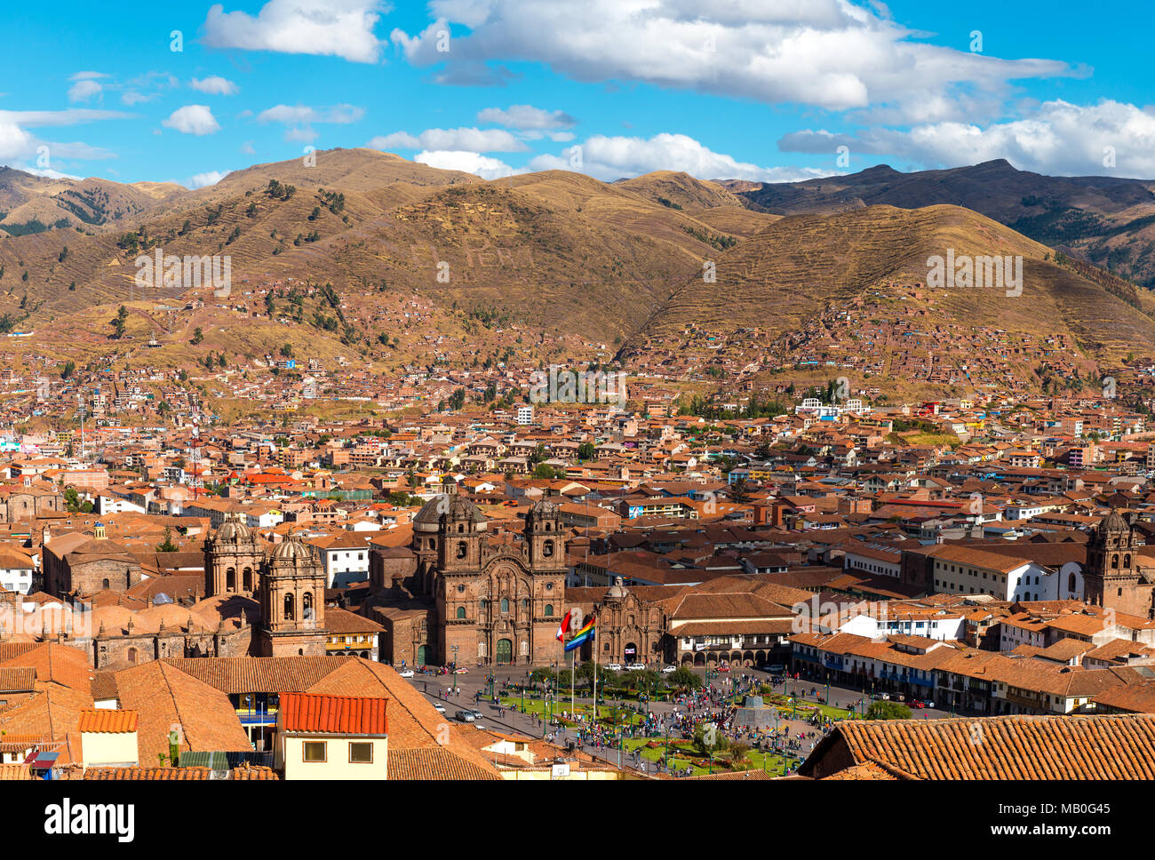 The urban skyline of Cusco city during daytime with the Plaza de Armas and cathedral and the Andes mountain range in the background, Peru. Stock Photo