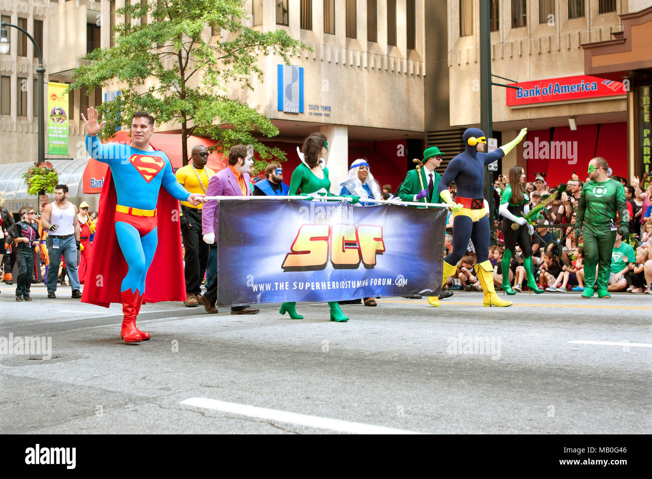 Superman character carries banner while walking down Peachtree Street in the annual Dragon Con parade, on August 31, 2013 in Atlanta, GA. Stock Photo