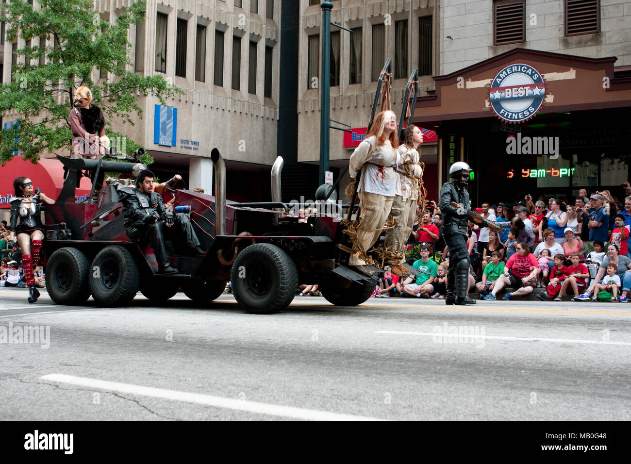 A vehicle from the Road Warrior movie, with human shields out front, terrorizes the crowd at the Dragon Con parade on August 31, 2013 in Atlanta, GA. Stock Photo