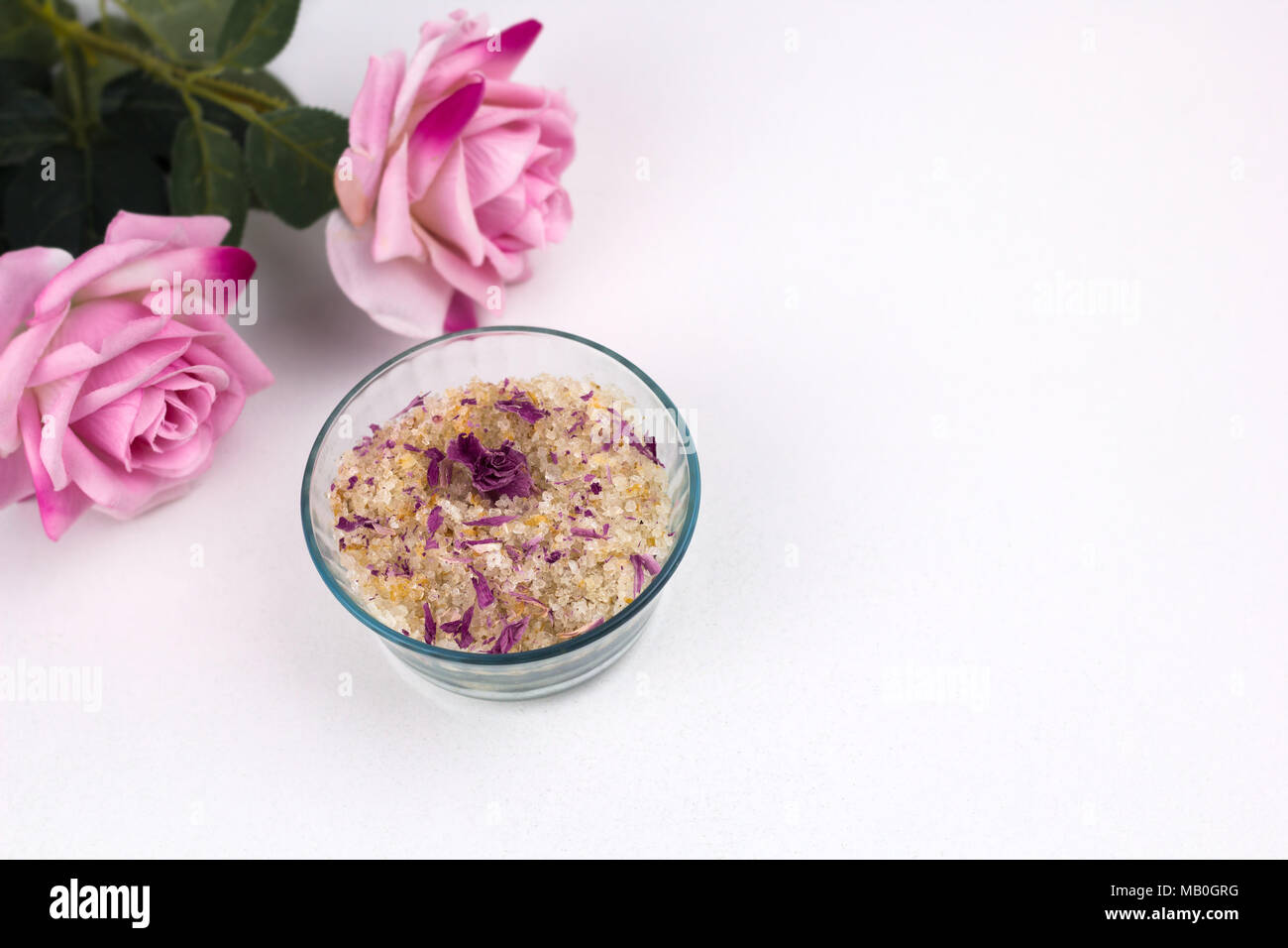 top view homemade scrub with sea solt,aroma oils and rose petals Stock Photo