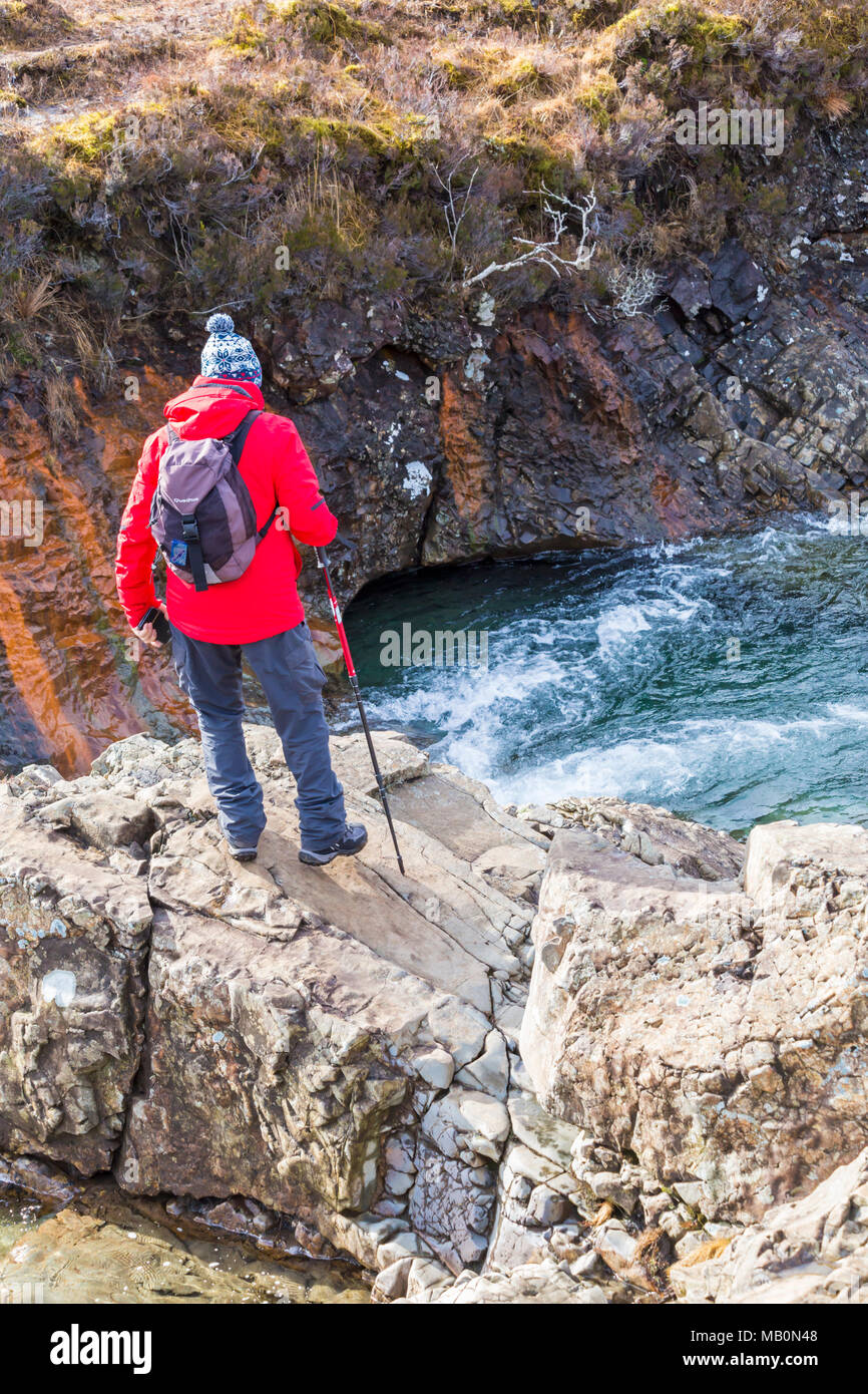 Man standing on rocks at Fairy Pools, river Brittle, Isle of Skye, Scotland, UK in March Stock Photo