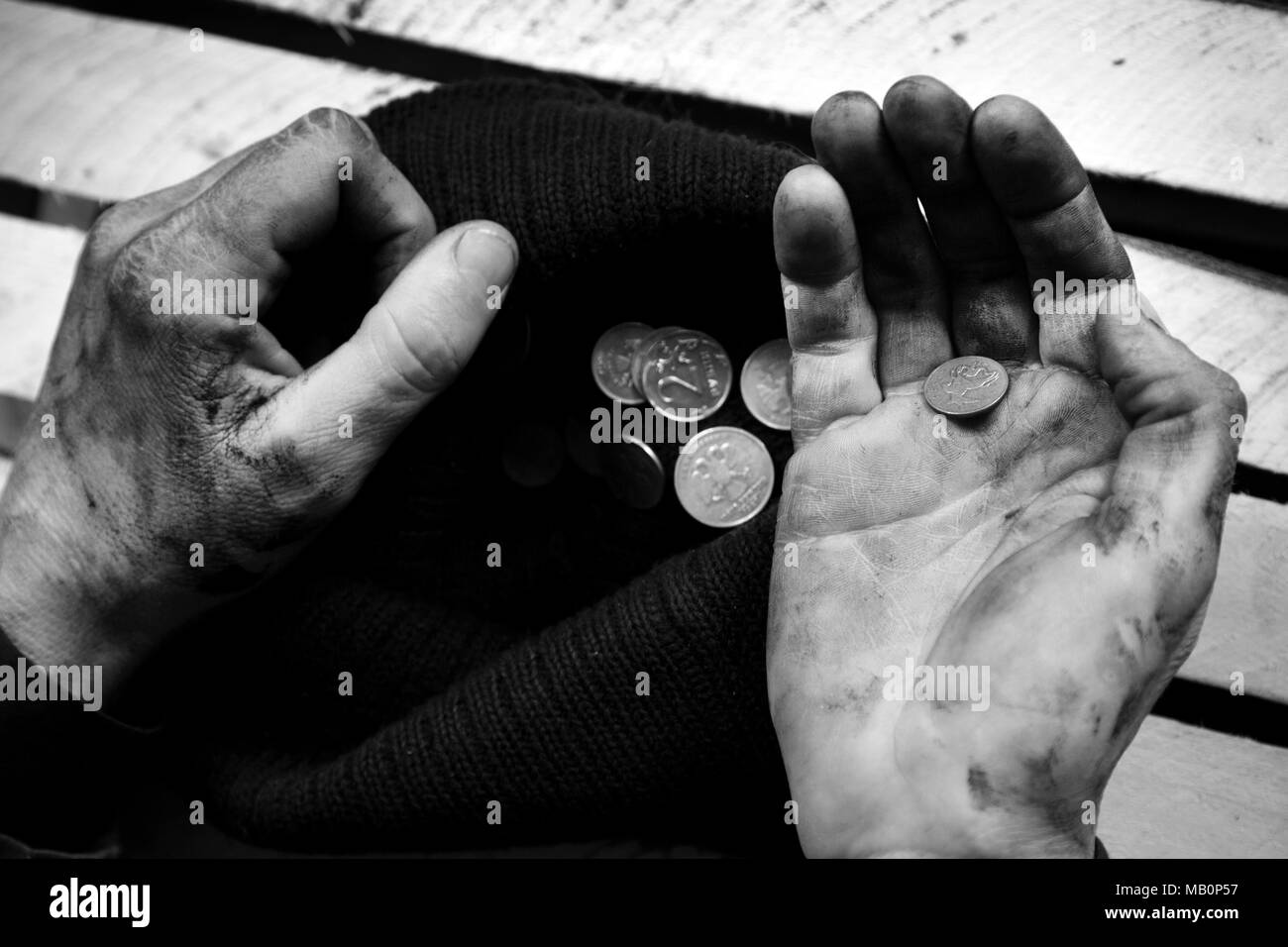 A beggar on the street is holding dirty hands with money Stock Photo