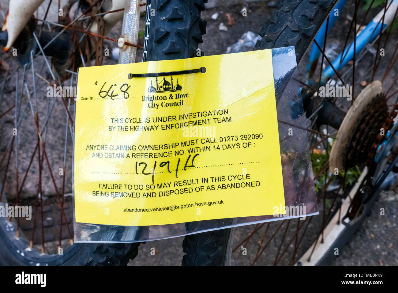England, East Sussex, Brighton, Illegally Parked Bicycle Removal Sign Stock Photo