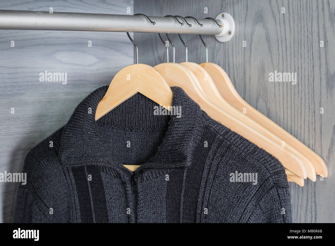 https://c8.alamy.com/comp/MB0R6B/a-hanger-with-things-knitted-sweaters-hang-on-hangers-bright-sweaters-spring-clothes-MB0R6B.jpg