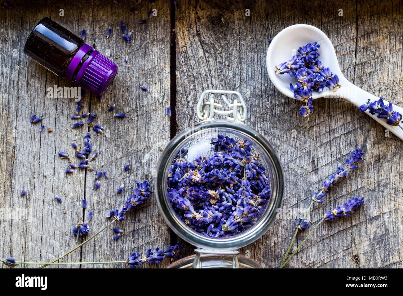 dried lavender flowers and lavender oil on wooden vintage background - herbal background Stock Photo