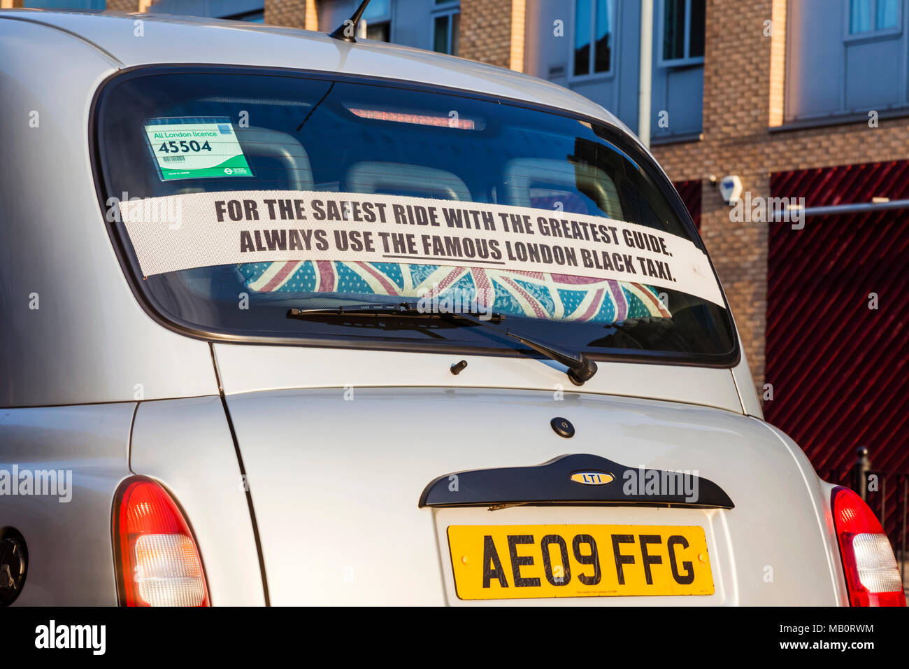 England, London, Advertising Slogan in Back Window of Traditional London Black Taxi Stock Photo