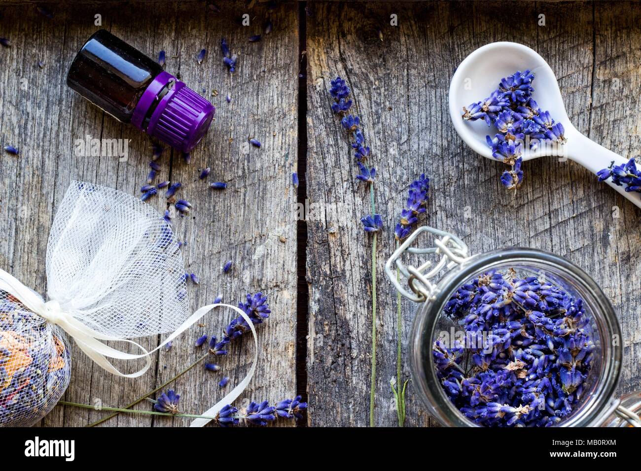 dried lavender flowers and lavender oil on wooden vintage background - herbal background Stock Photo