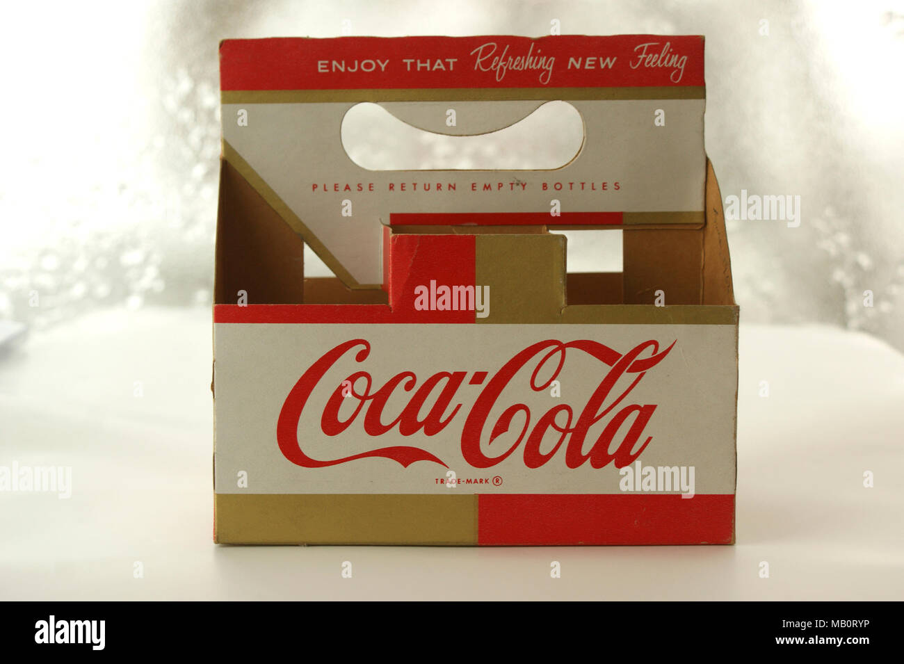 Coca Cola cardboard carrying holder from 1960s, designed to hold six small bottles. These were used to recycle glass bottles, which had a deposit value payable on them from the retailer. Stock Photo