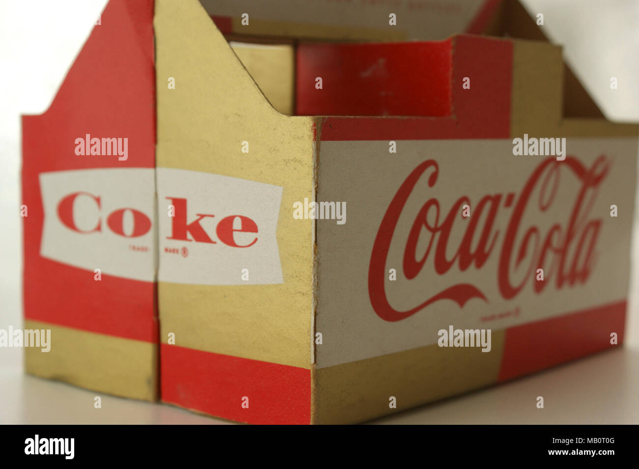 Coca Cola cardboard carrying holder from 1960s, designed to hold six small bottles. These were used to recycle glass bottles, which had a deposit value payable on them from the retailer. Stock Photo