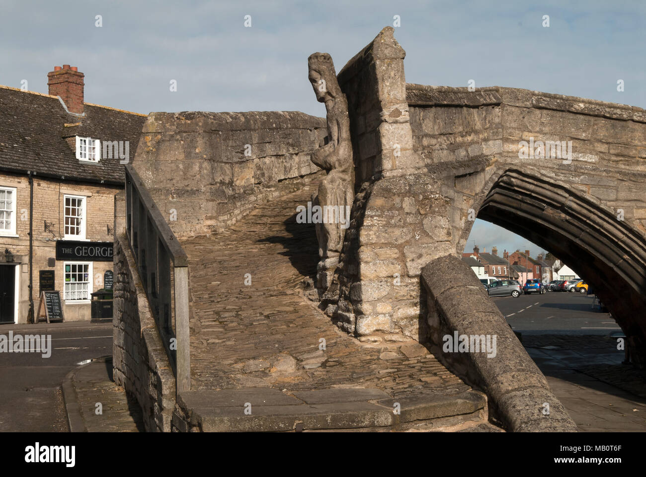 Crowland Trinity Bridge, Lincolnshire. Medieval sculpture of King Ethelbald or Aethelbald King of Mercia. Originally on the Abbey but fell off a long time ago and repositioned on the famous bridge. HOMER SYKES Stock Photo