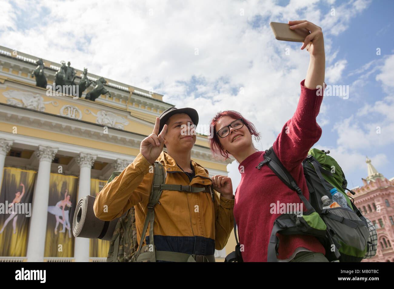 Two young hikers taking selfies in front of a historic building Stock ...